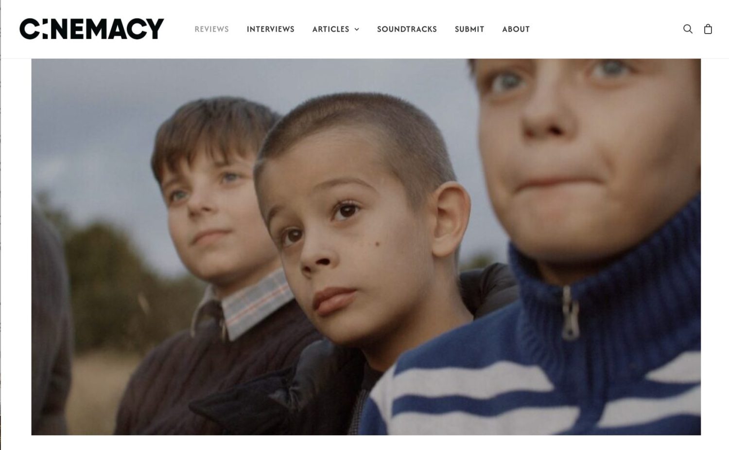 Three young boys watch the sunset