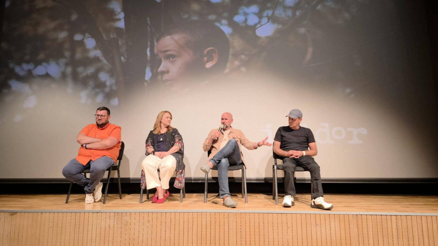 Filmmakers sitting on stage for post-screening talk